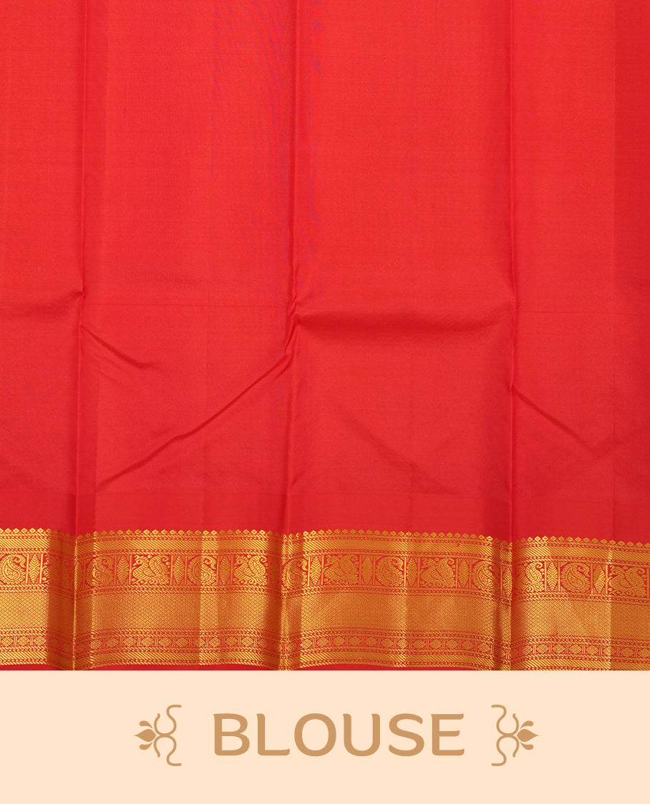 Peacock colour Vasundhara silk saree adorned with all-over gold mayil motifs on the body, complemented by a contrast red colour with gold traditional with mayil pattern border and paired with a matching blouse piece.
