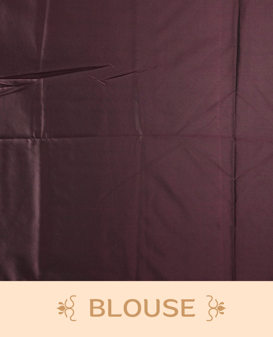 Dark mauve colour semi soft silk saree adorned with delicate woven floral motifs on the body, complemented by a rich contrast deep chocolate colour woven pallu with intricate detailing and tassel accents. Comes with a matching blouse piece