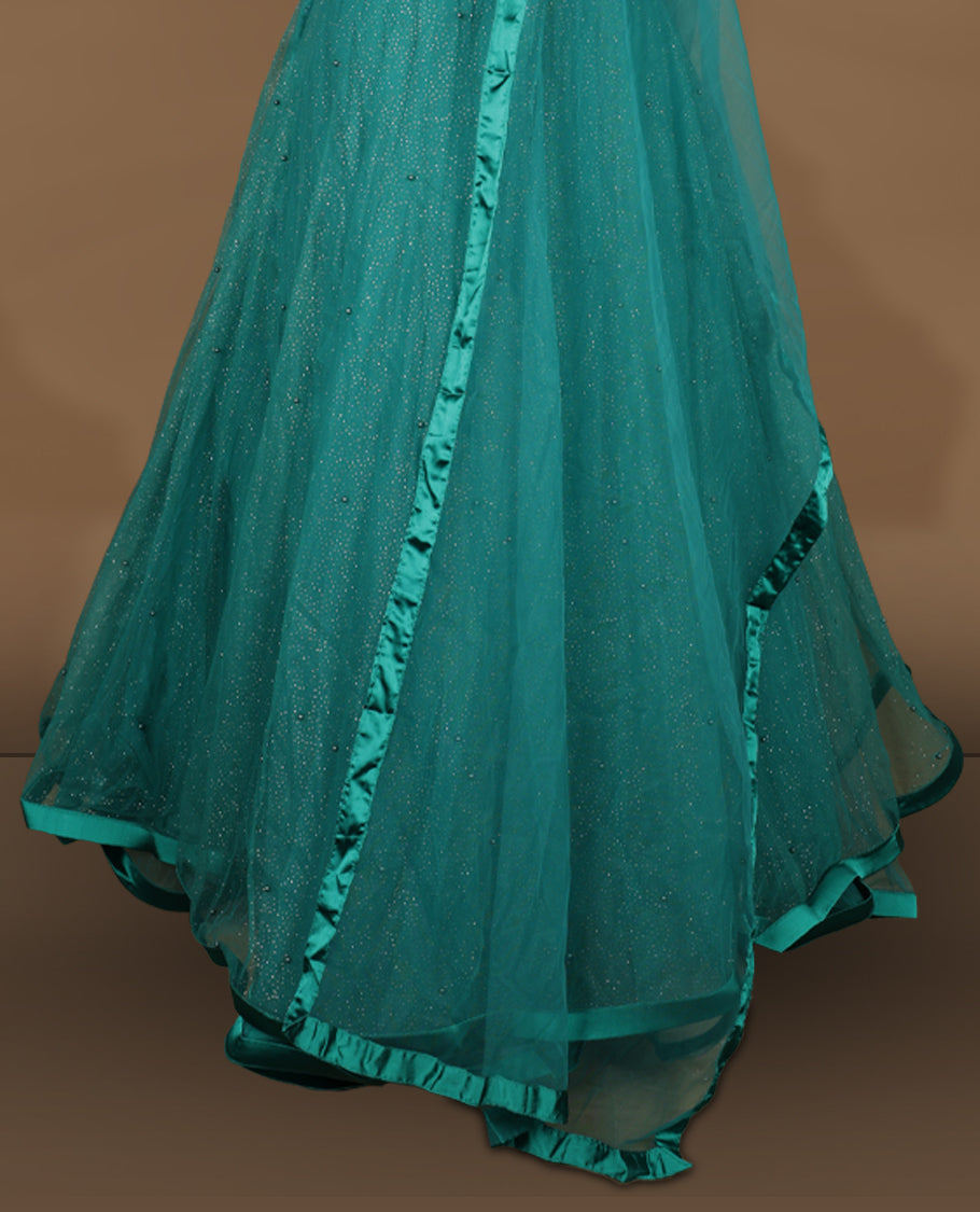 Teal green colour lehenga set with stitched sleeveless blouse featuring floral sequin embroidery on neckline and waist, paired with a matching shimmer layered flared lehenga and sheer dupatta