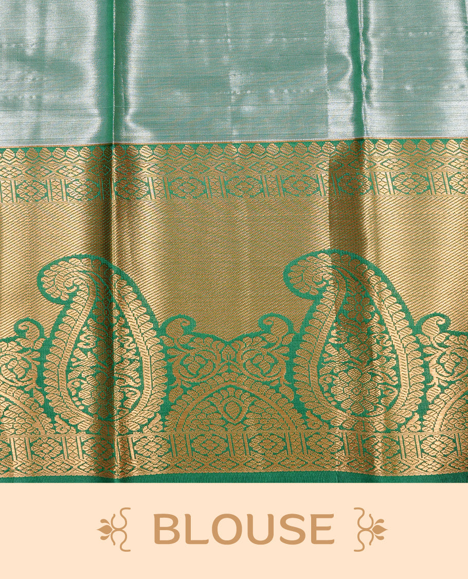 Light purple colour tissue saree featuring silver & gold zari floral kodi pattern on the body, highlighted by a contrast Green colour border with gold traditional zari, paired with a matching blouse piece.
