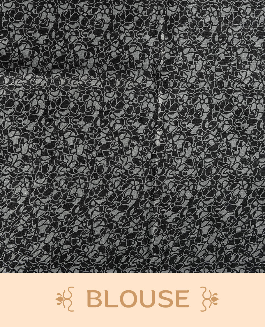 Grey colour saree with striking black floral patterns, merging modern minimalism with timeless charm & paired with a matching blouse.