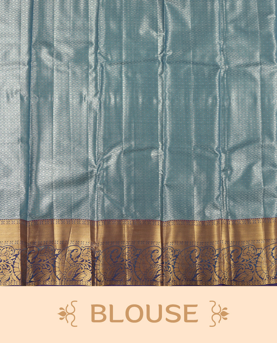 Blue colour tissue brocade saree with delicate floral and leaf motifs in antique gold zari work throughout body. Ornate gold border and pallu with traditional floral scrolls, navy blue accents. Includes coordinating blouse.