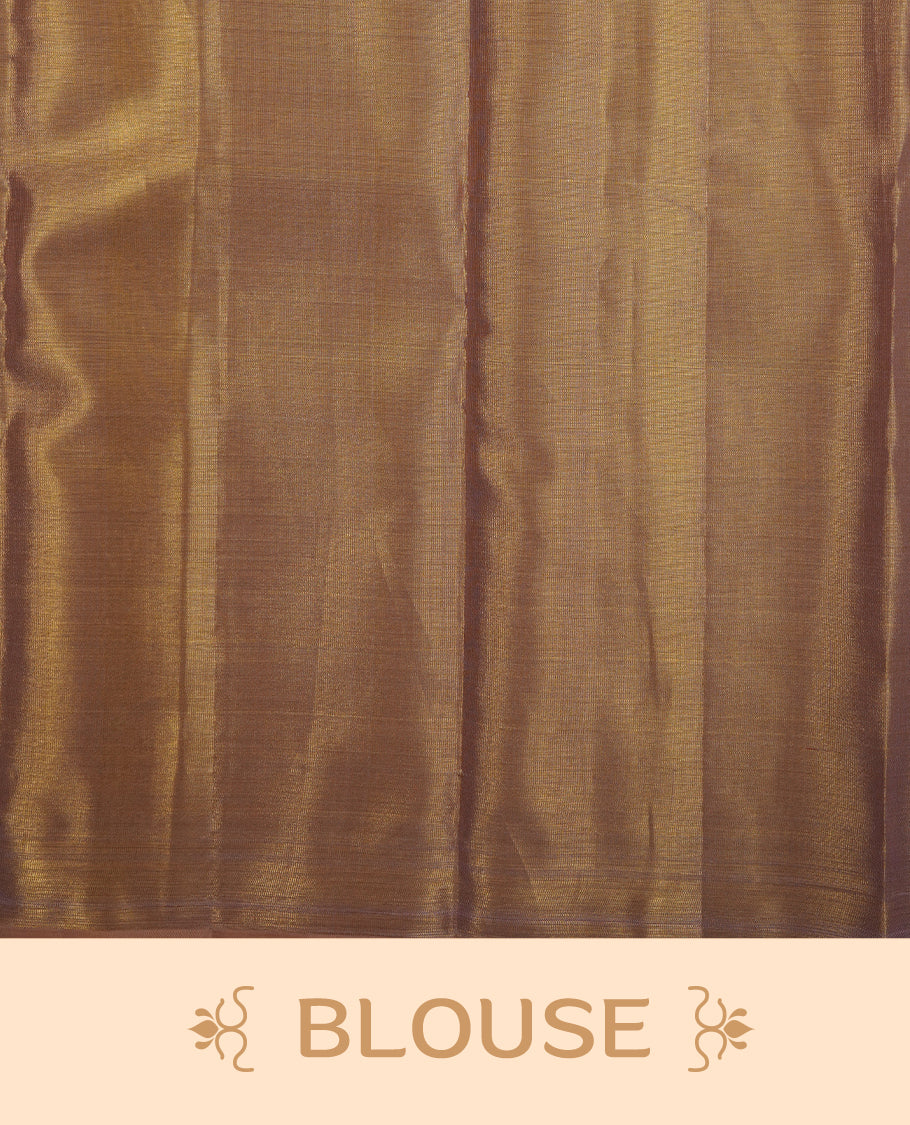 Gold colour kancheepuram tissue silk saree highlighting gold zari pattern body, with contrast Light pinkish beige colour colour with traditional border and paired with matching blouse.