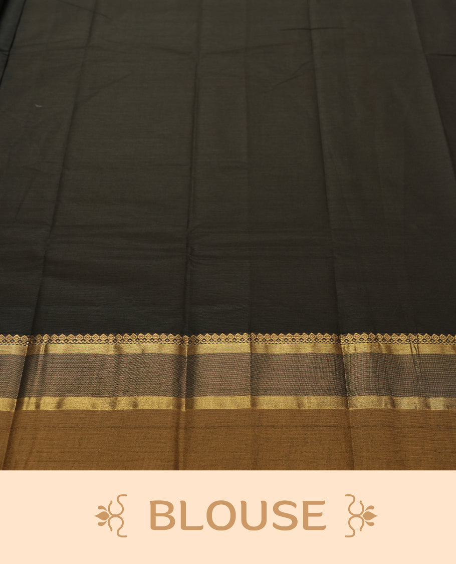 Black Colour silk cotton saree with scattered pink and orange buttas, gold and bronze temple border with pink floral band, gold zari pallu with leaf patterns, black blouse with bronze border.