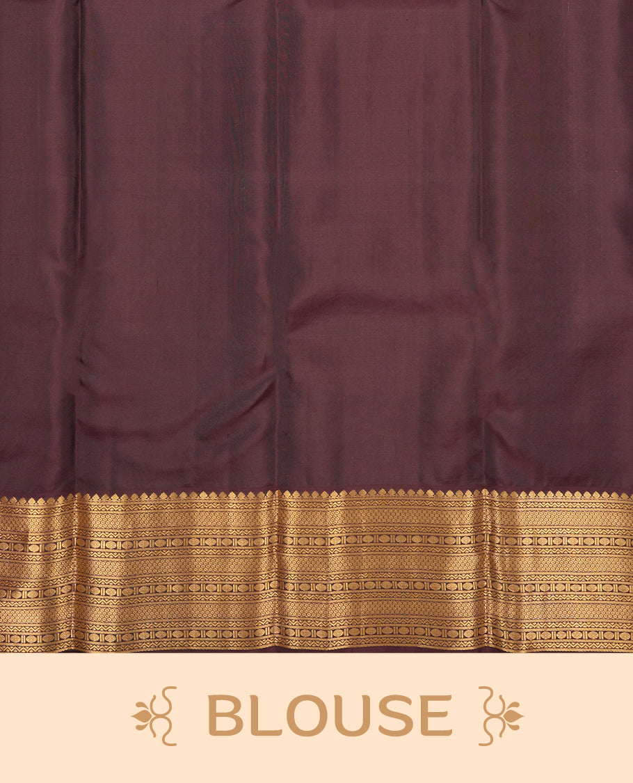 Baby pink colour Vasundhara silk saree adorned with all-over gold two head mayil motifs on the body, complemented by a  contrast brown colour with gold traditional border and paired with a matching blouse piece.