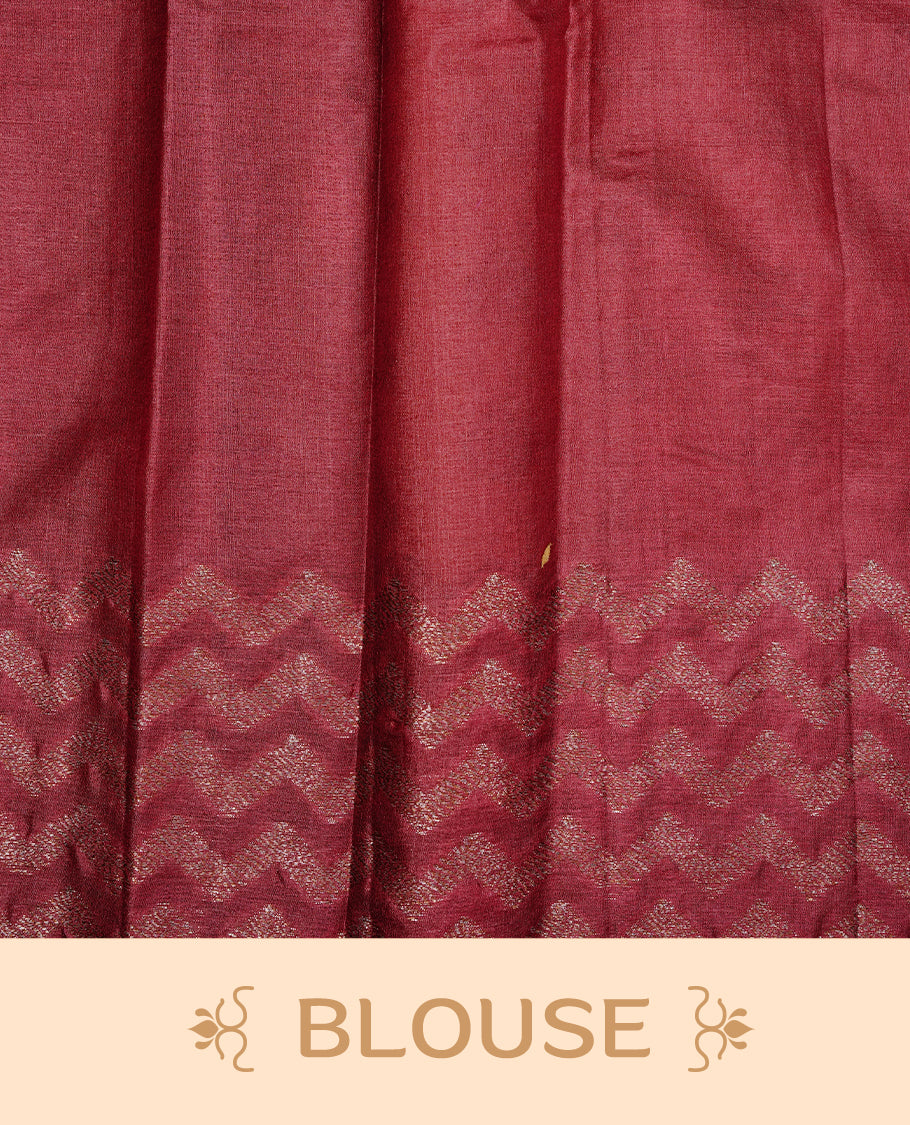 Peach Colour Tussar silk saree featuring Antique Zari motifs on body, Finished with contrast Maroon colour Zigzag zari pattern border, paired with matching blouse piece.