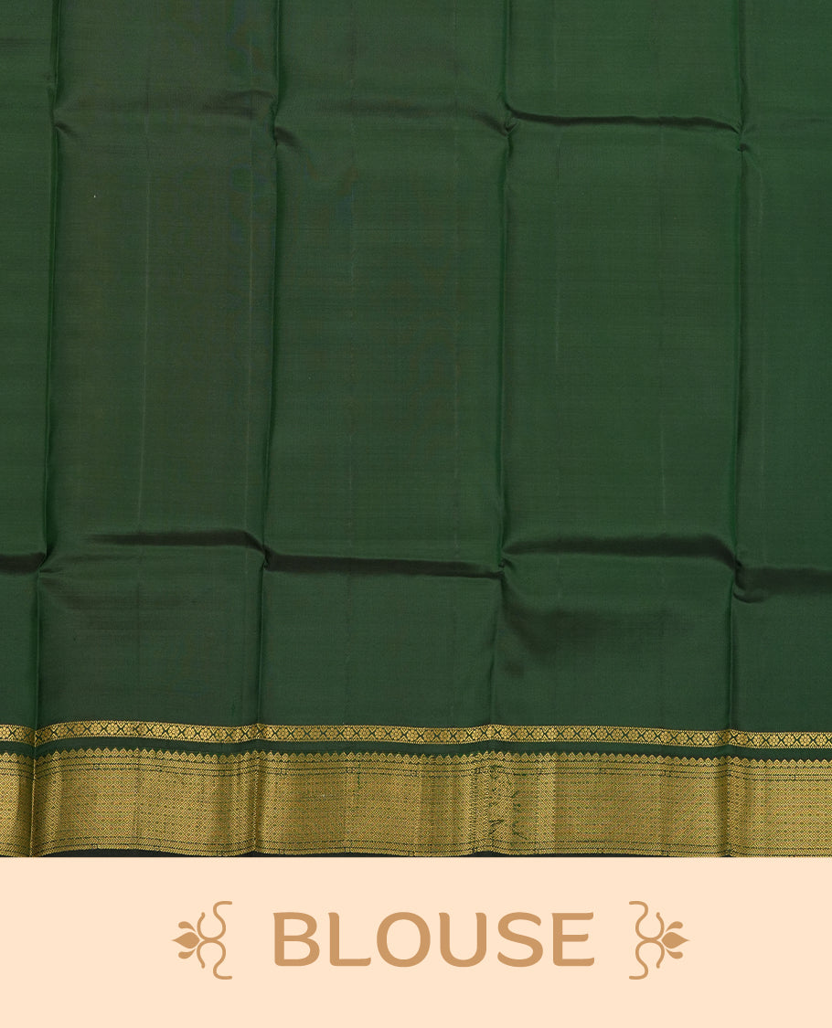 Mustard Yellow colour Vasundhara silk saree adorned with all-over gold motifs on the body, complemented by a contrast dark green colour with gold mayil motifs border and paired with a matching blouse piece.