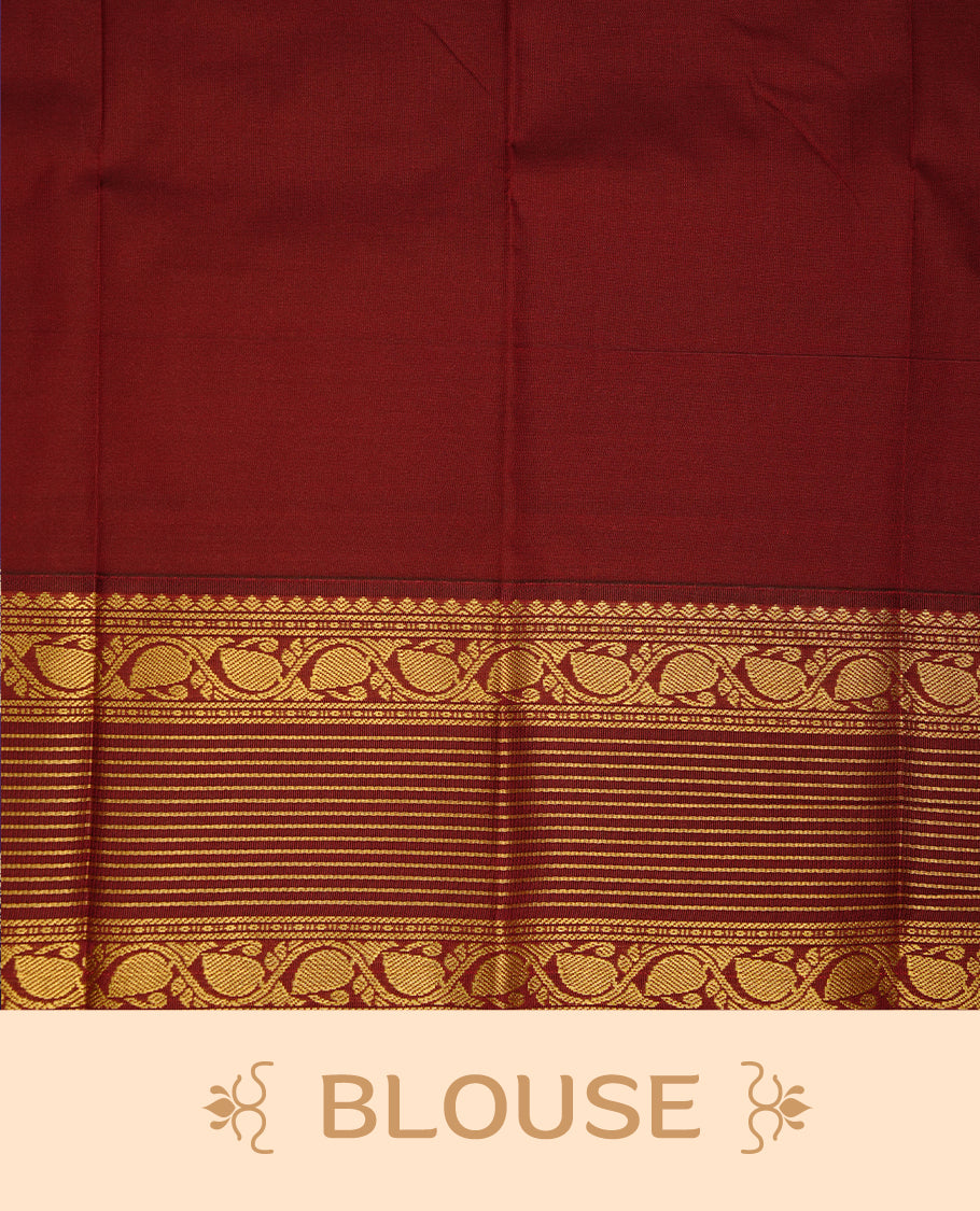 Mustard coloured soft silk saree featuring gold zari stripes and motifs across the body, enhanced with a contrast Maroon border and pallu, paired with a matching contrast blouse piece.