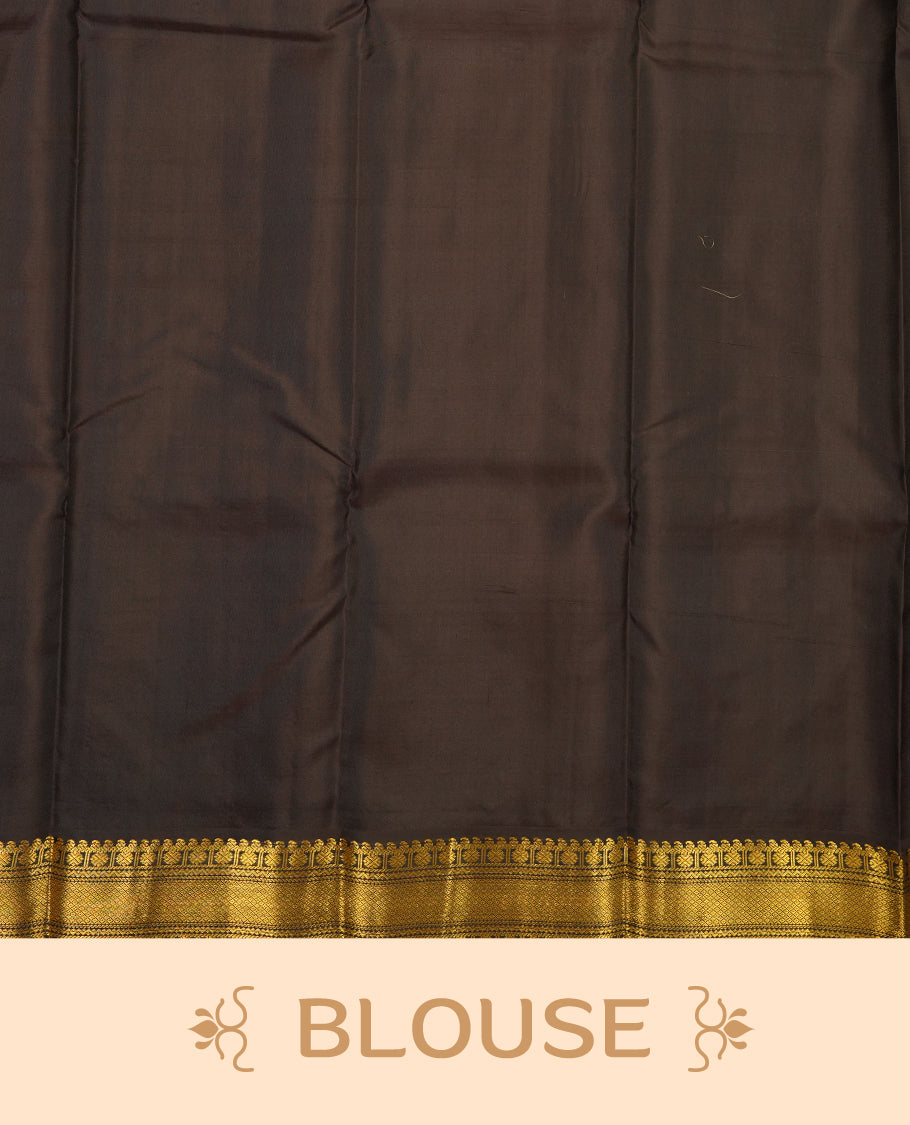 Pinkish red colour Vasundhara silk saree adorned with all-over gold zari motifs on the body, complemented by a contast black colour with gold motifs on border and paired with a matching blouse piece.