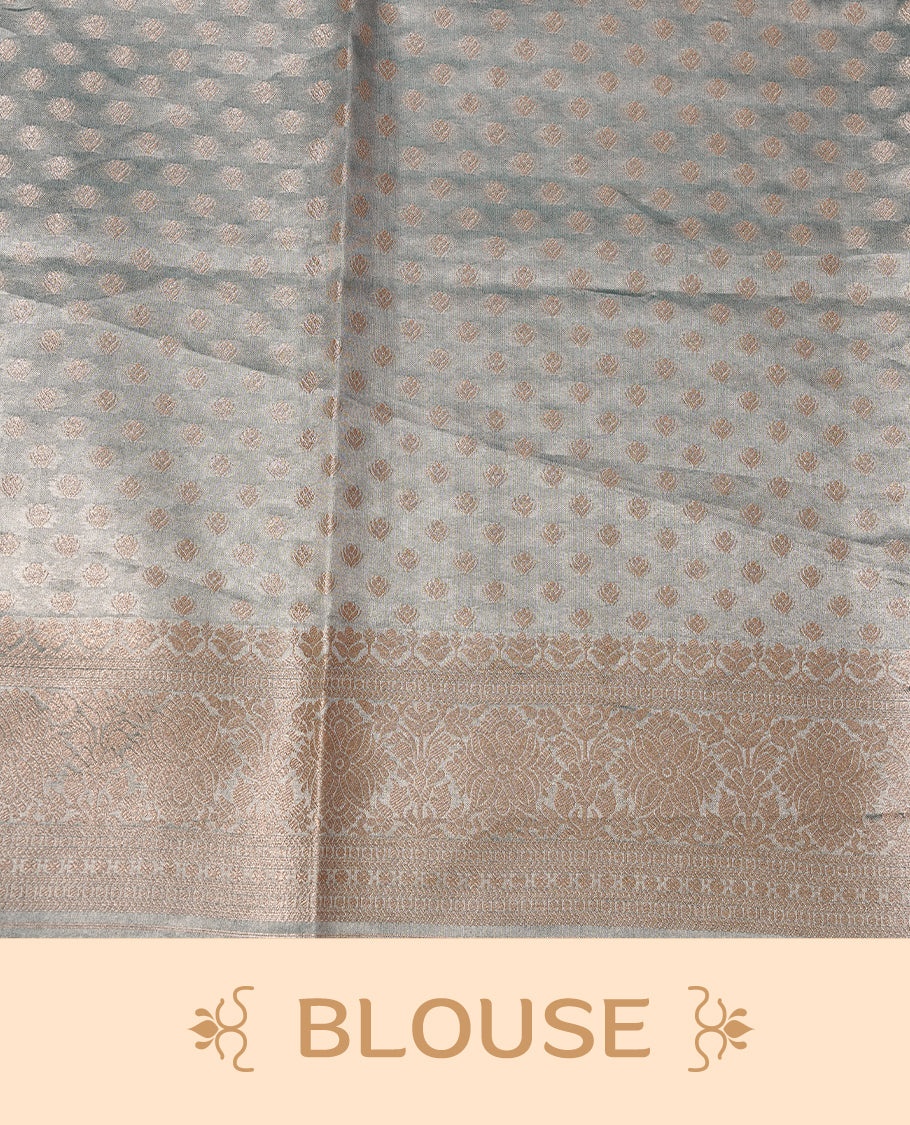 Pastel Aqua colour semi tissue silk saree featuring floral zari motifs on body, complemented by gold zari traditional border, paired with matching blouse piece.
