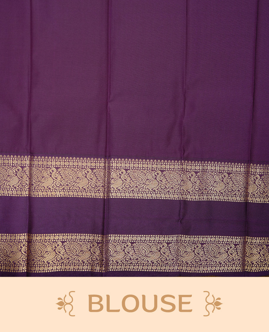 Rust orange coloured soft silk saree featuring gold zari stripes and motifs across the body, enhanced with a contrast Purple border and pallu, paired with a matching contrast blouse piece.
