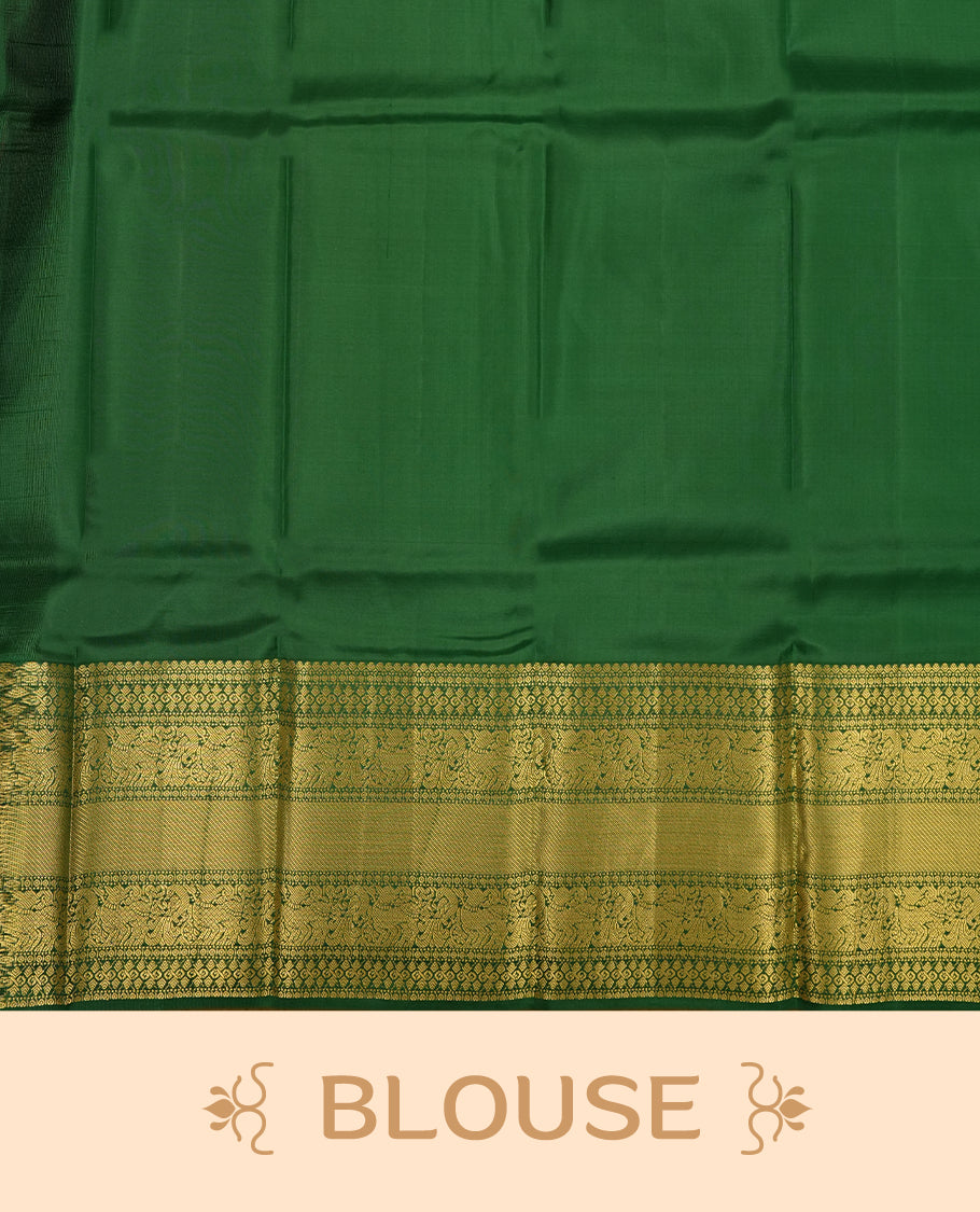 Rani pink colour Vasundhara silk saree adorned with all-over gold motifs on the body, complemented by a contrast green with gold tarditional border and paired with a matching blouse piece.