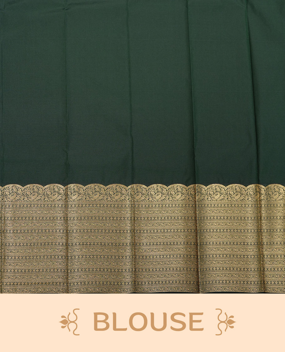 Dark green coloured soft silk saree featuring gold zari stripes and motifs across the body, enhanced with selfcolour border and pallu, paired with a matching blouse piece.