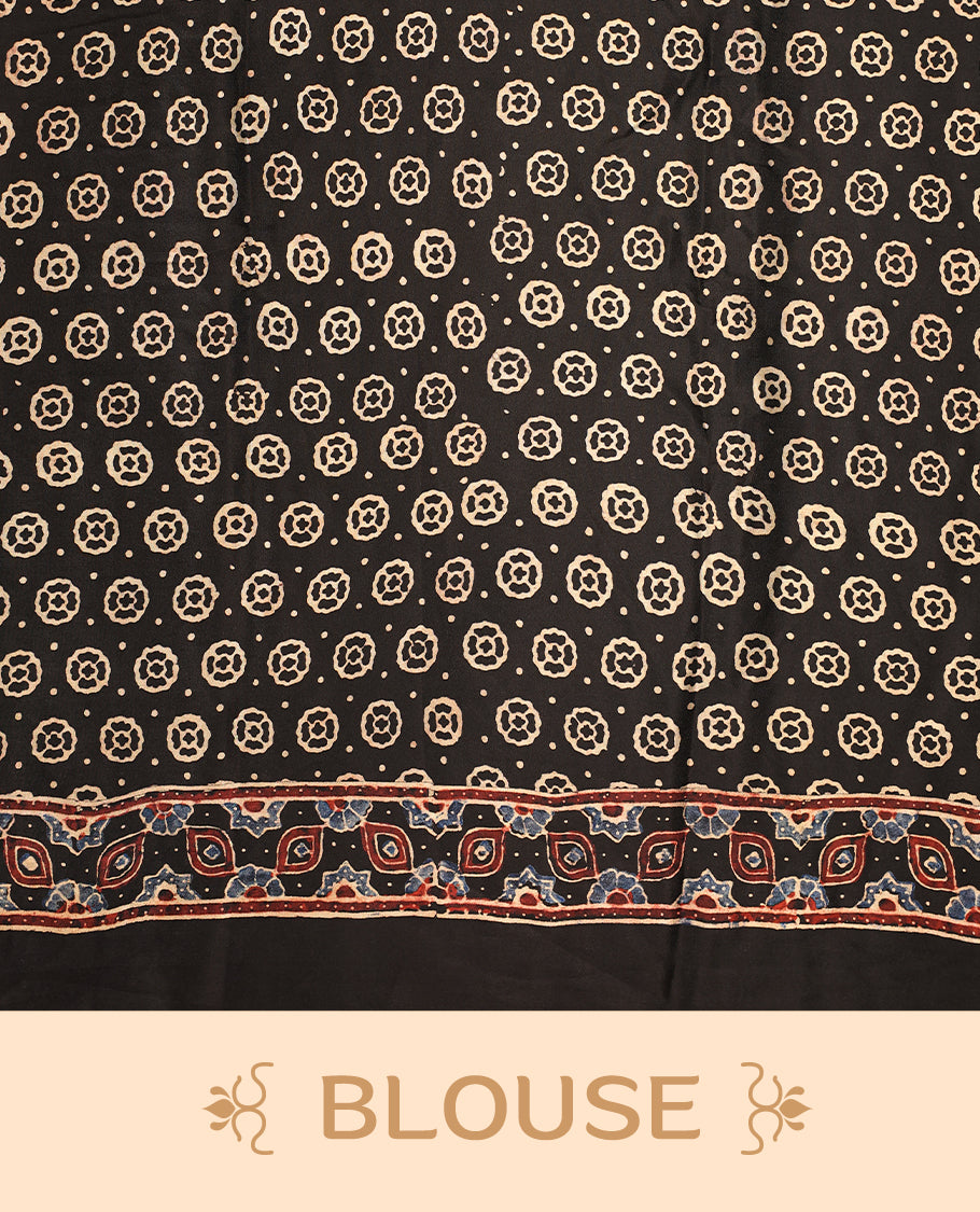 Black colour saree featuring intricate multicolour ethnic prints across the body and pallu, highlighted with a subtle golden border and traditional motifs, paired with a matching blouse.