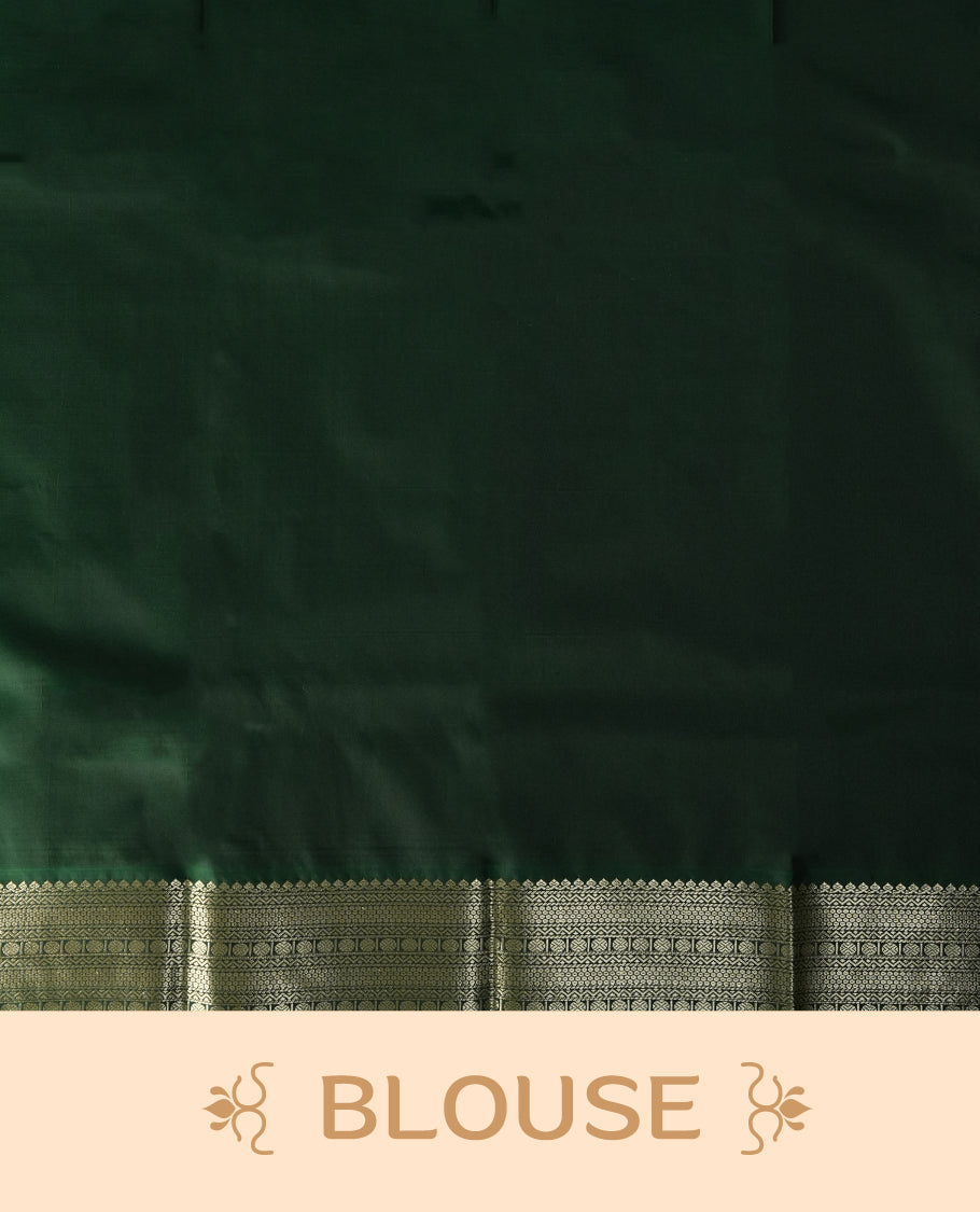 Mustard yellow colour soft silk saree adorned with golden buttas, highlighted by a rich green border and pallu with intricate zari designs & Paired with a matching blouse.