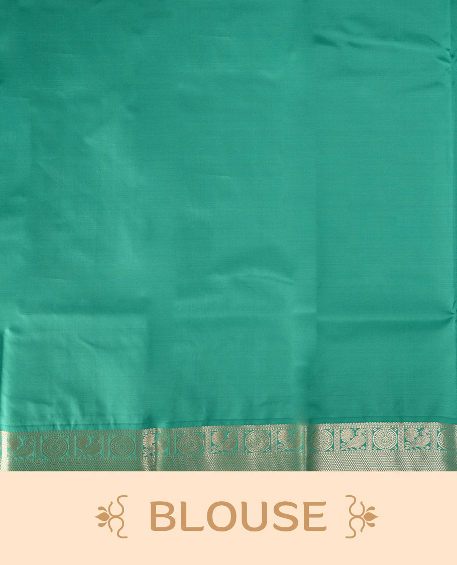 Deep plum colour body soft silk saree adorned with silver buttas, paired with a contrasting light aqua green zari border & Comes with a matching blouse.
