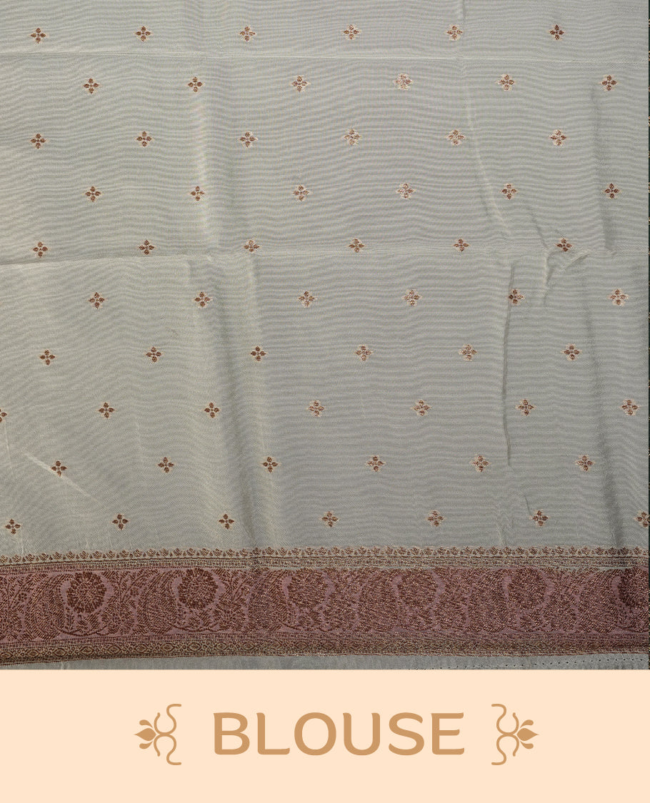 Pastel cream colour semi Banarasi Tussar Georgette saree with blush pink and lilac zari floral motifs, ornate dusty rose border and rich pallu & Includes a matching unstitched blouse piece to complete the look.