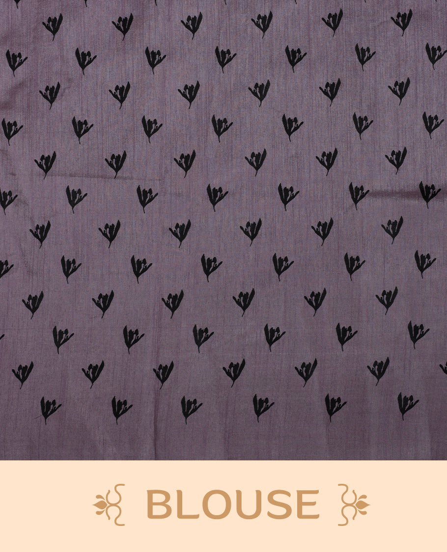 Pastel Lavender colour Semi tussar silk saree adorned with black floral prints on the body and an elegant pallu & Comes with a matching blouse piece for a classy look.