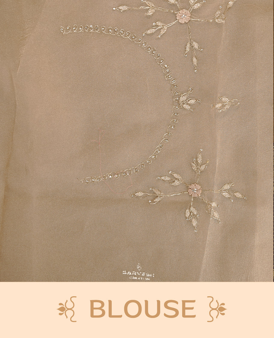 Light coffee colour crush organza saree featuring gold thread floral and stone worked  body, highlighting scalp designed border, paired with matching blouse piece.