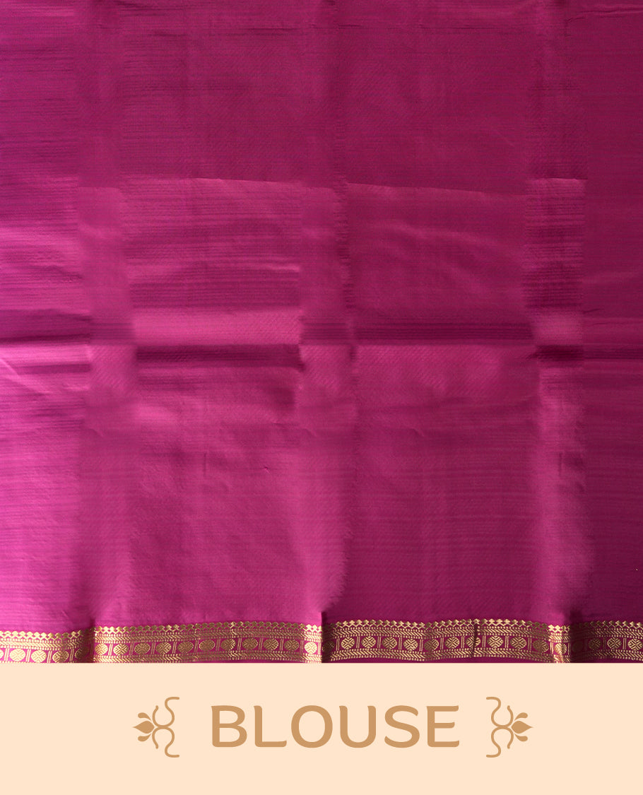 Dark maroon colour soft silk saree with subtle golden buttas, accentuated by a pink zari border and pallu & Paired with a matching blouse.