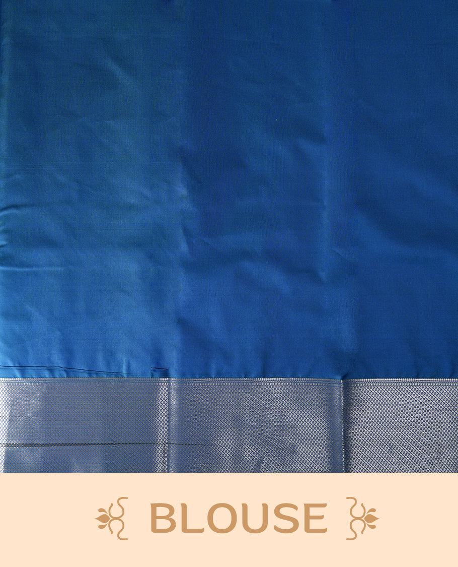 Royal blue colour soft silk saree adorned with small silver buttas, enhanced by a shimmering silver zari border and pallu with delicate motifs & paired with a matching blouse.