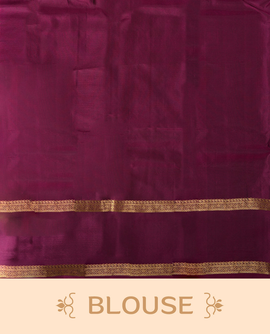 Brown colour soft silk saree adorned with golden zari motifs, complemented by a rich purple border and pallu & Paired with a matching blouse.