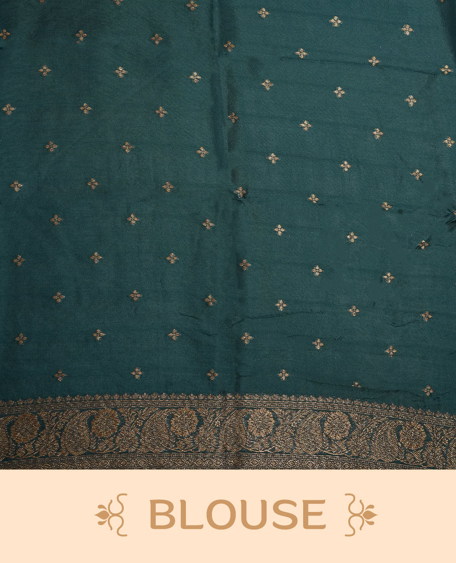 Deep peacock blue colour semi Banarasi Tussar Georgette saree with gold zari motifs on the body, a grand woven golden pallu, and ornate zari border. Includes a matching blouse piece for a complete look.