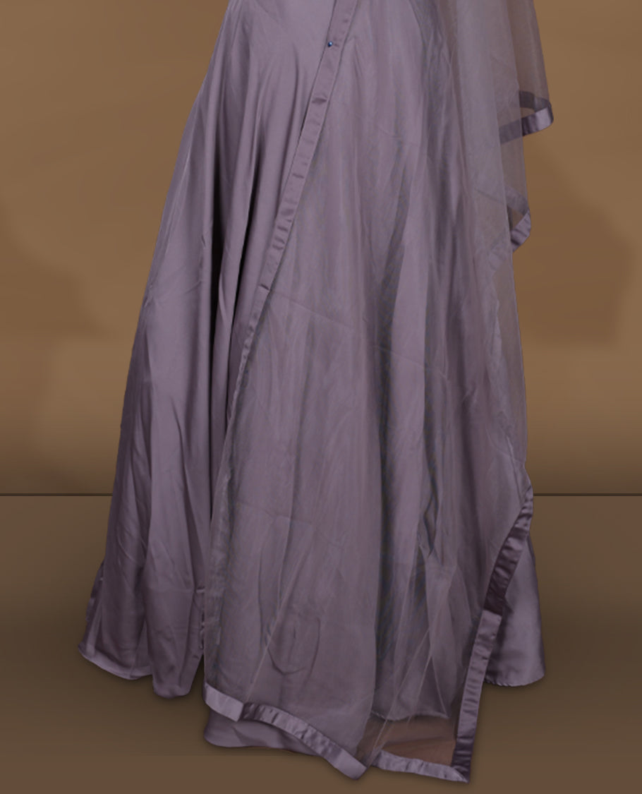 Dusty lavender colour lehenga set with stitched sleeveless blouse featuring intricate bead and sequin embroidery along the neckline and waist, paired with a matching stitched flared lehenga and plain sheer dupatta.