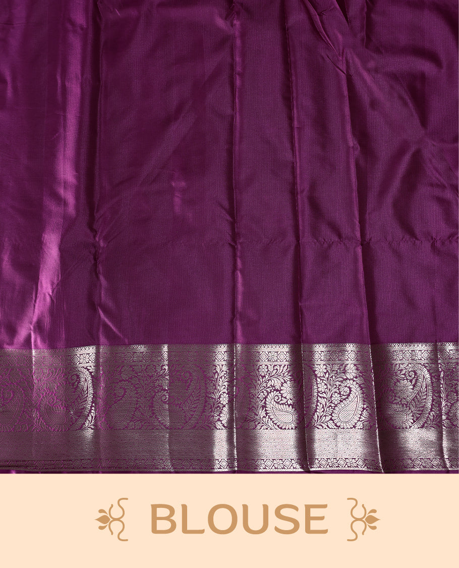 Grape colour semi silk brocade saree featuring intricate golden zari floral and geometric patterns all over the body, complemented by a rich self-colour woven border and pallu, paired with a matching blouse.