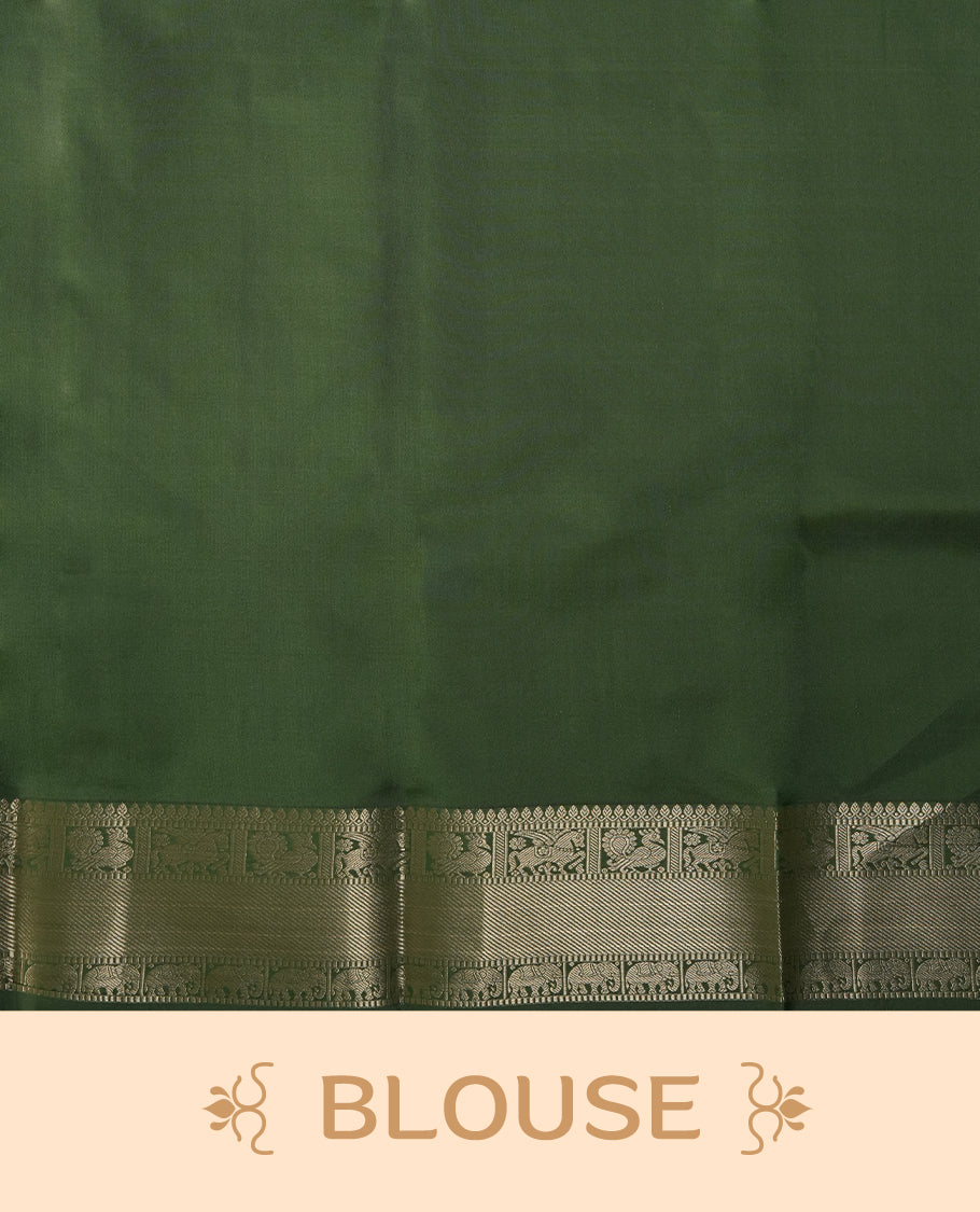 Dark pista green colour soft silk saree adorned with small golden buttas, enhanced by a shimmering gold zari border and pallu with delicate motifs & Paired with a matching blouse.