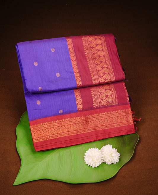 Indigo colour kalyani cotton saree featuring antique zari motifs on body, complemented by Maroon colour with Antique zari border, paired with matching blouse piece.