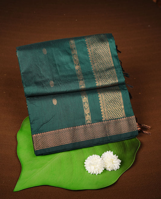 Dark green colour kalyani cotton saree featuring gold zari motifs on body, complemented by selfcolour with Antique zari border, paired with matching blouse piece.