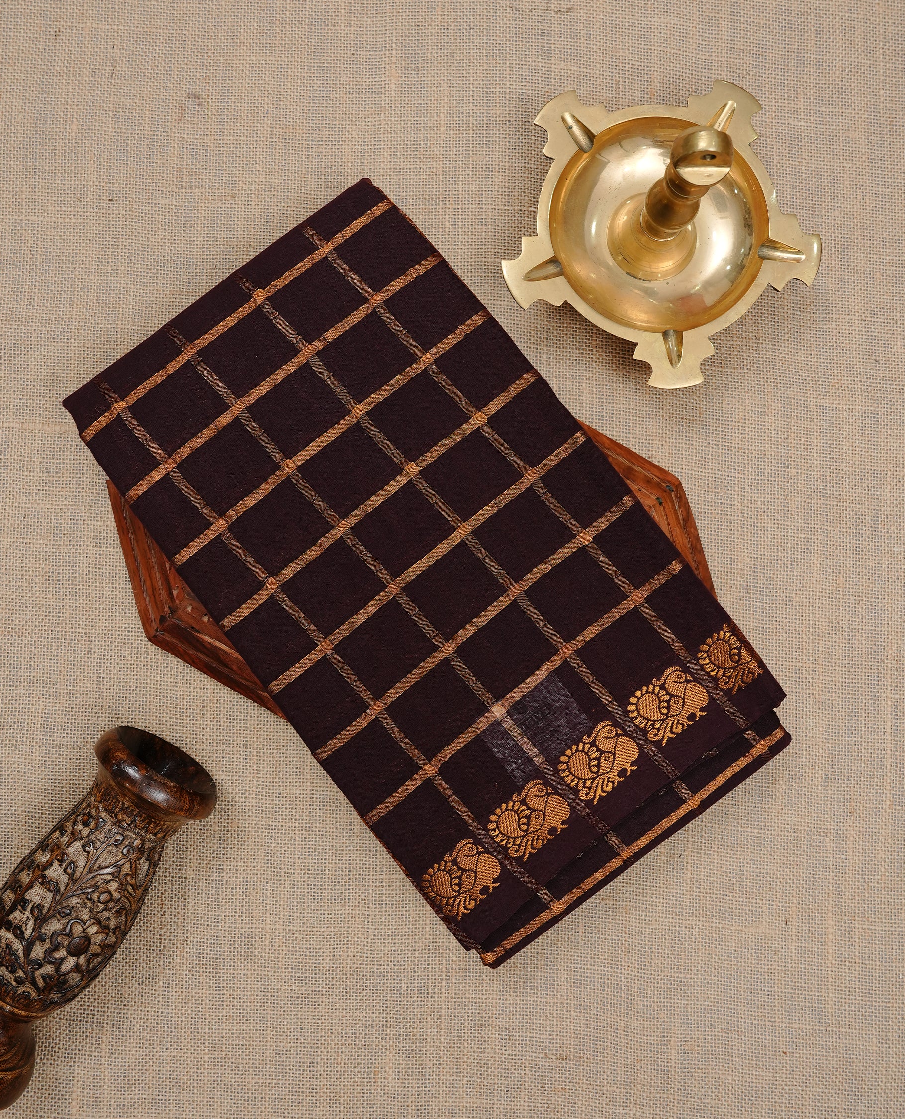 Dark chocolate colour Sungudi cotton saree featuring Gold zari Check pattern on body, Gold zari Peacock design on Self colour border, paired with matching blouse piece.