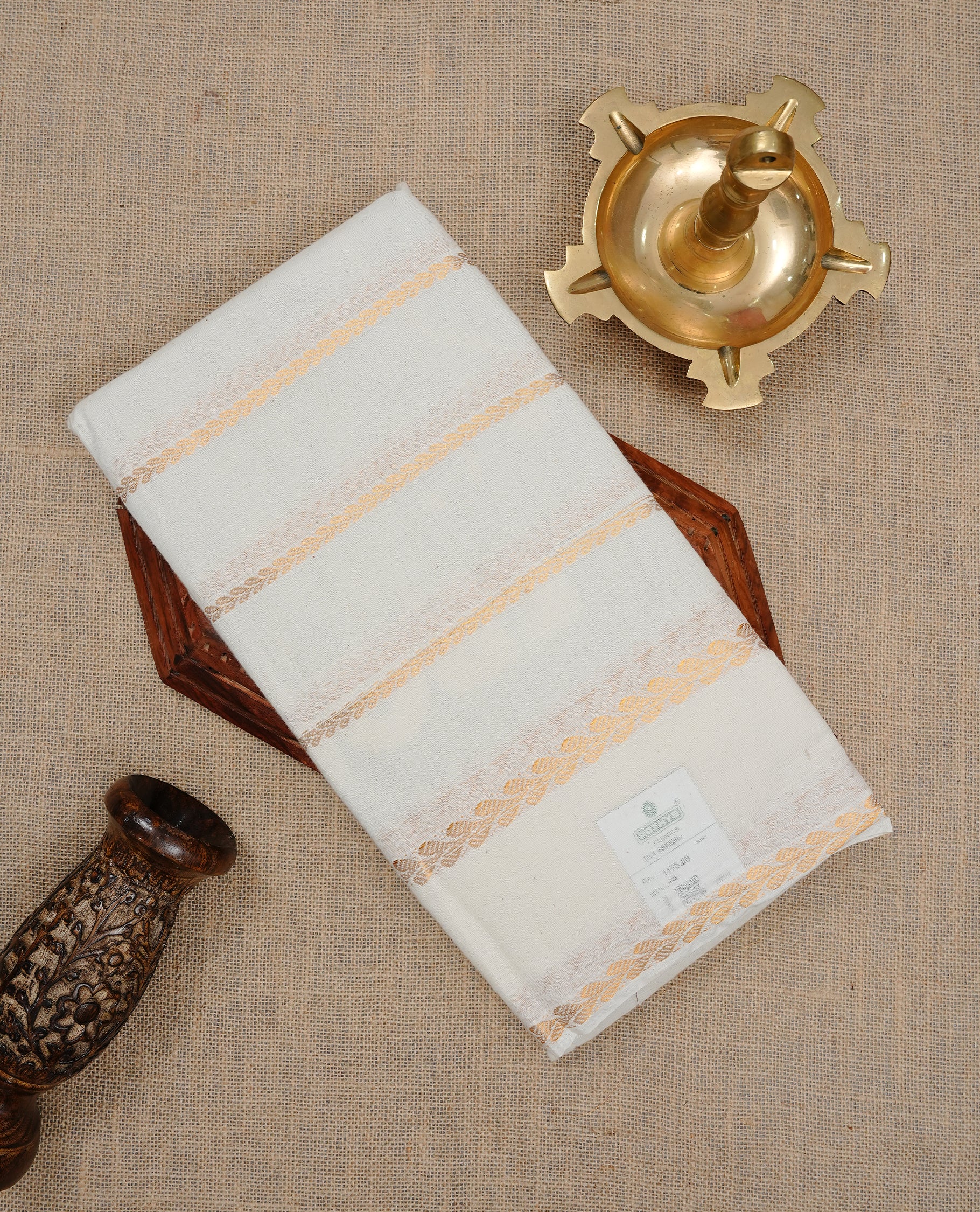 Off white colour Sungudi cotton saree featuring Gold zari stripes on body, Gold zari design on Self colour border, paired with matching blouse piece.