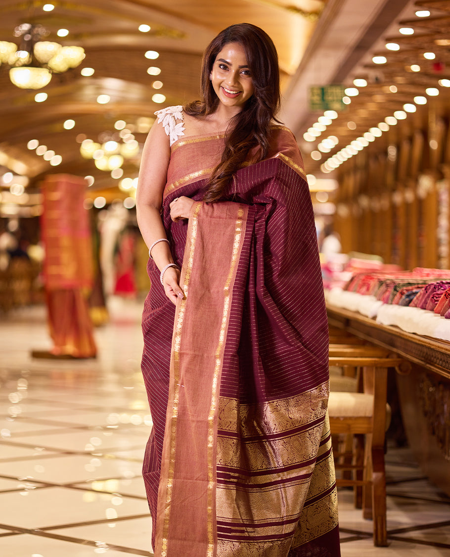 Deep maroon colour Kanchi cotton saree featuring antique zari stripes on the body, traditional temple borders, a grand pallu, and paired with a matching blouse
