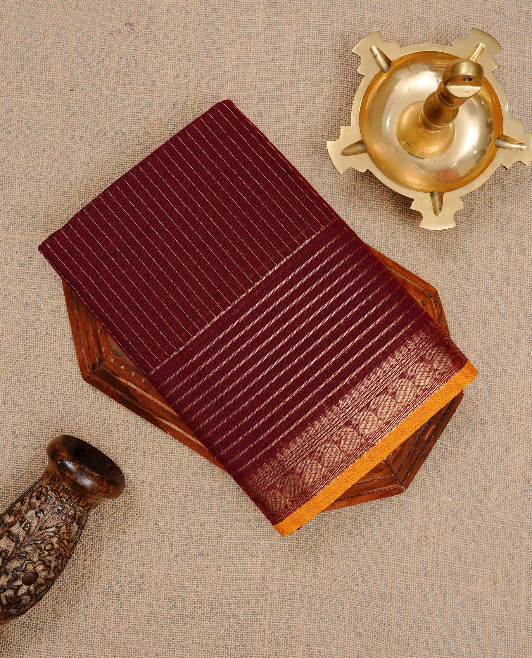 Maroon colour Chettinad cotton saree featuring gold zari stripes on body , complemented by contrast Magenta colour with zari border, comes with matching blouse piece.