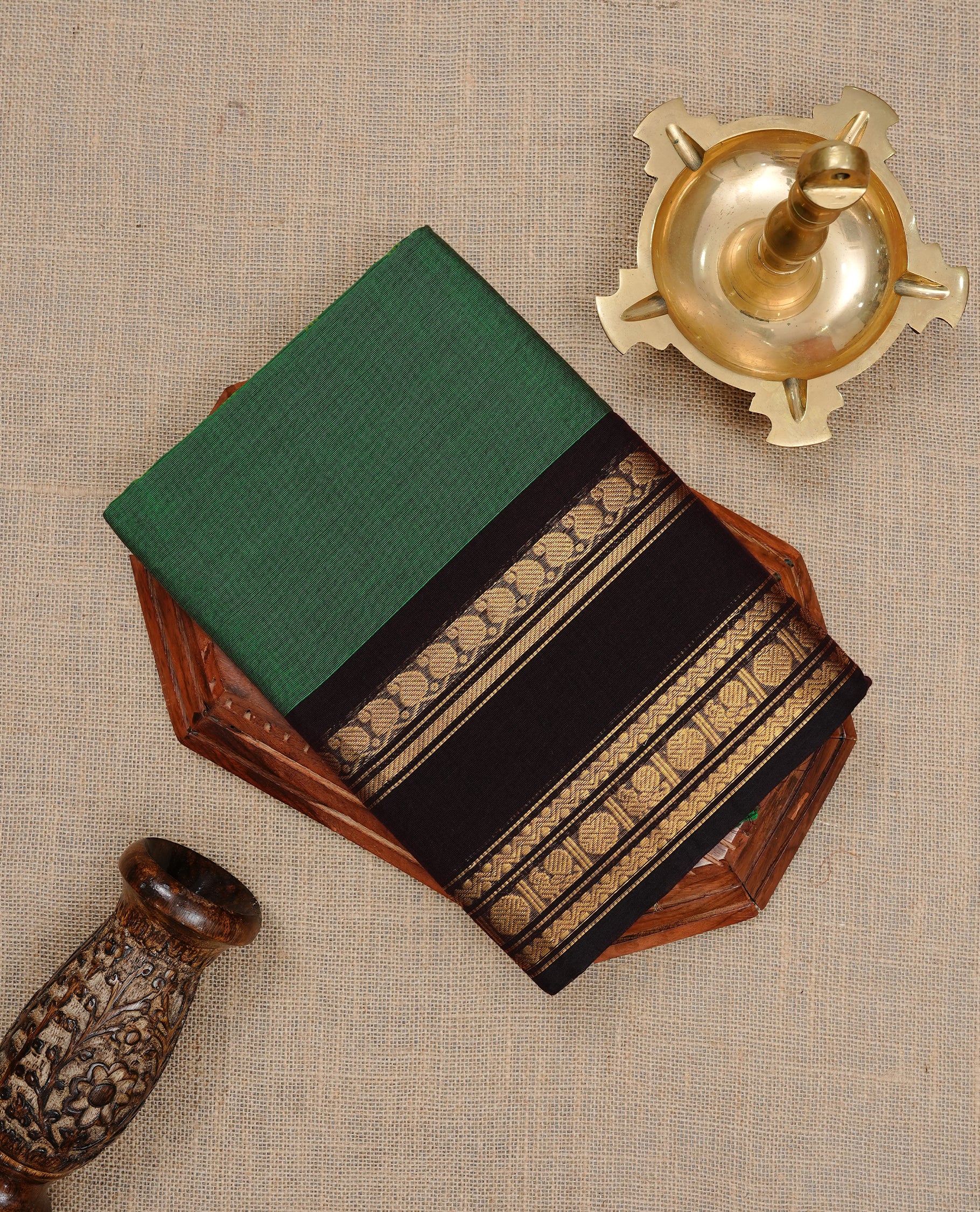Green colour Chettinad cotton saree featuring motifs on body , complemented by contrast Black colour with zari border, comes with matching blouse piece.