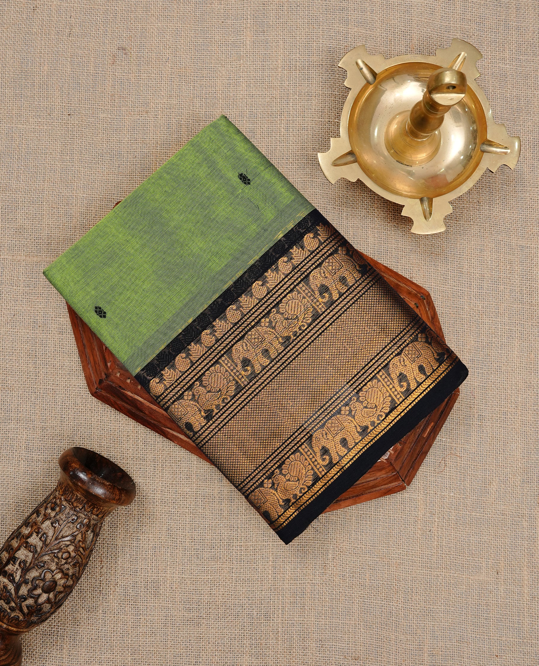 Green colour Narayanapett cotton saree Featuring Elegant plain Body, complemented by Contrast Black colour with cream zari border, paired with matching blouse piece.
