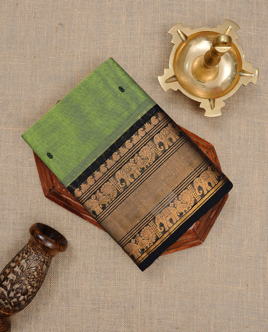 Green colour Narayanapett cotton saree Featuring Elegant plain Body, complemented by Contrast Black colour with cream zari border, paired with matching blouse piece.