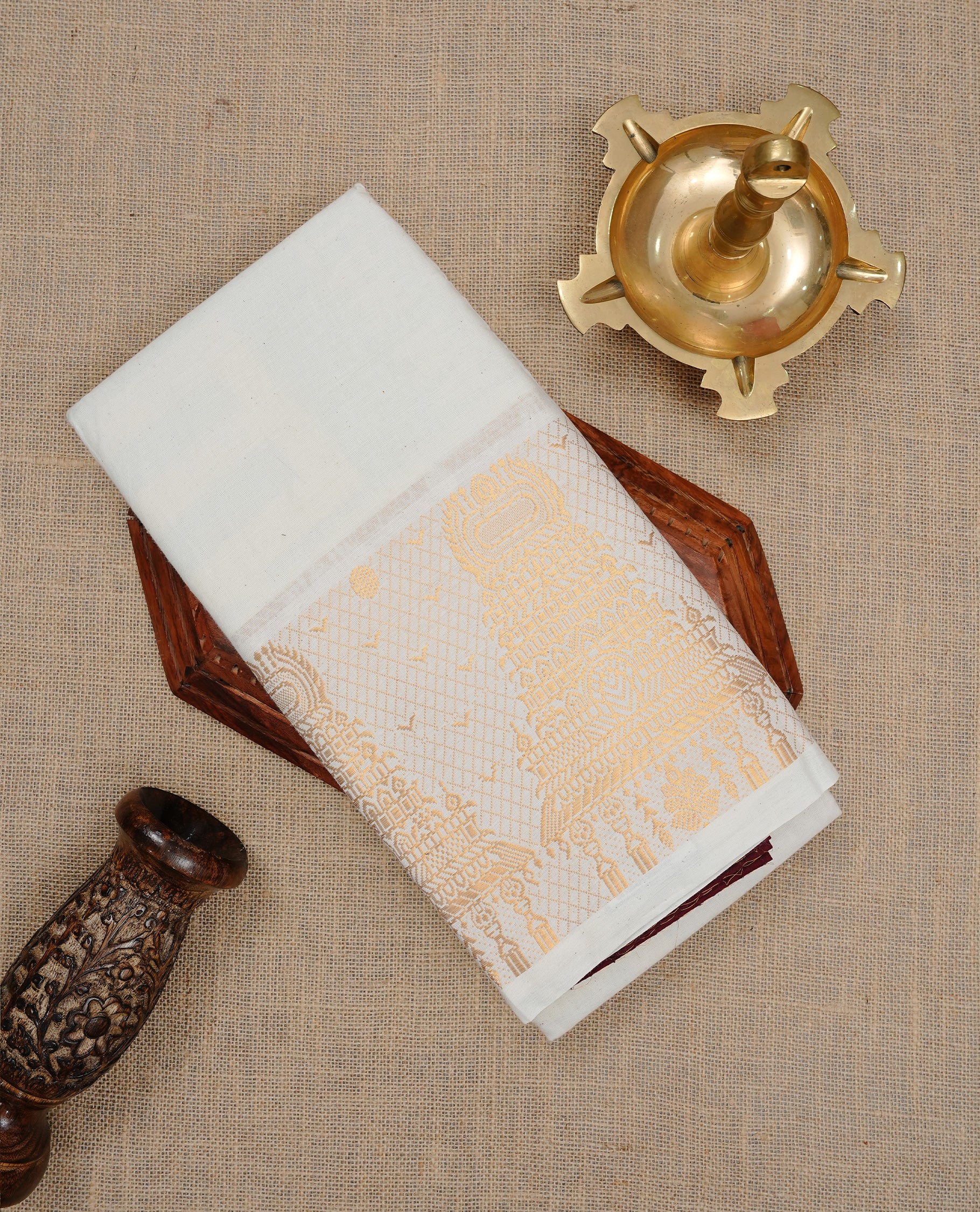 Off white colour Sungudi cotton saree featuring Elegant plain body, Gold zari temple design on Self colour border, paired with matching blouse piece.