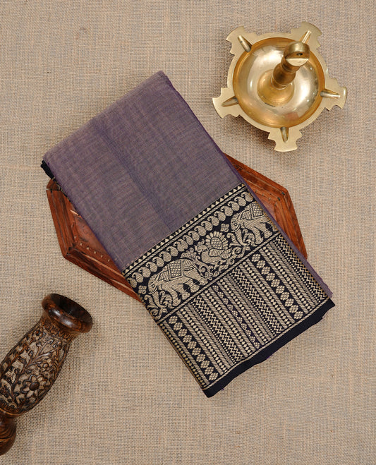Greyish Lavender colour Narayanapett cotton saree Featuring Elegant plain Body, complemented by Contrast Black colour with cream zari border, paired with matching blouse piece.
