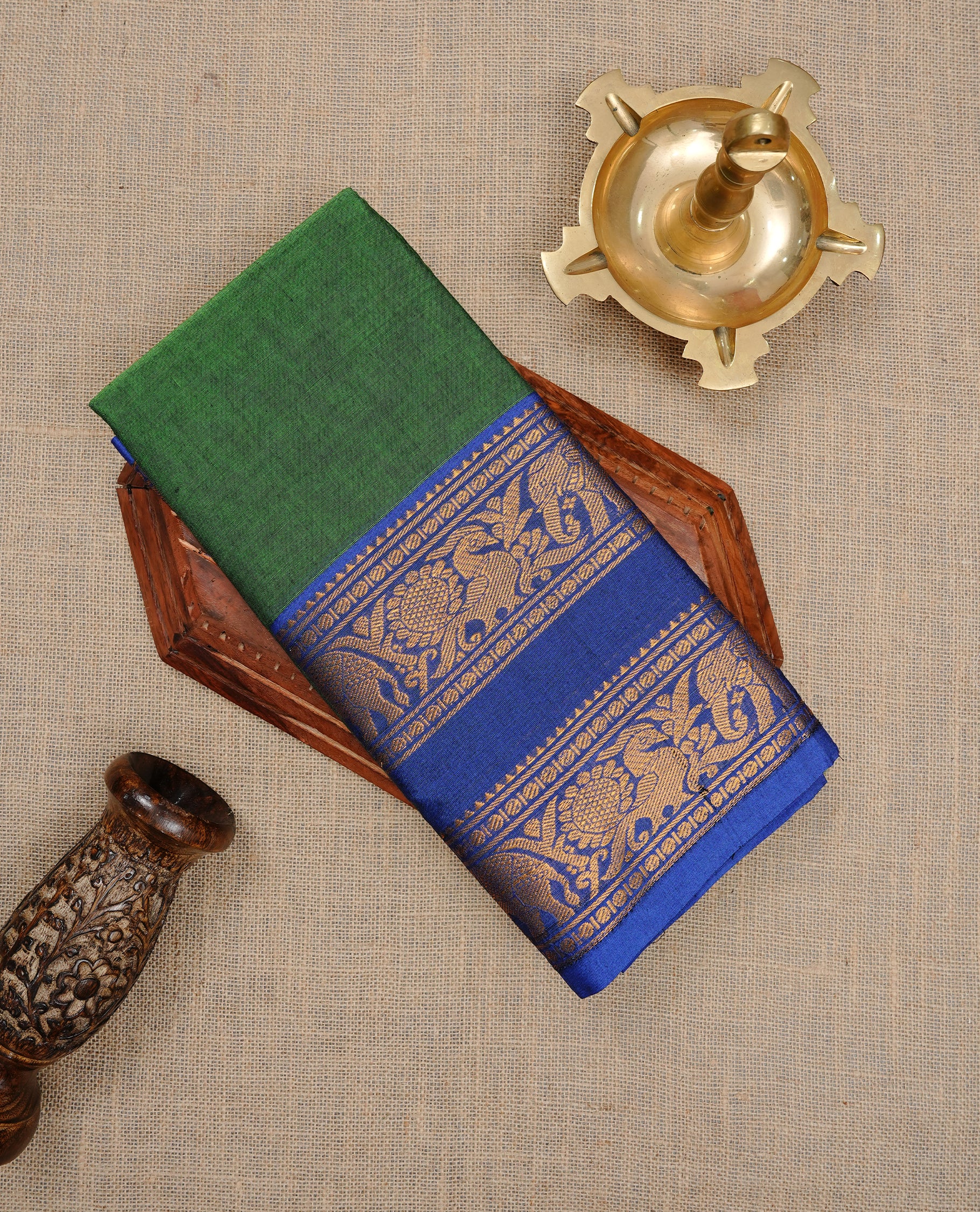 Green colour Sungudi cotton saree Featuring Elegant plain Body, complemented by Contrast Blue colour with cream zari border, paired with matching blouse piece.