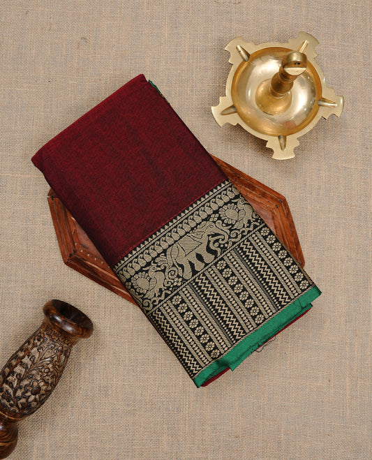 Maroon colour Narayanapett cotton saree Featuring Elegant plain Body, complemented by Contrast Black colour with cream zari border, paired with matching blouse piece.