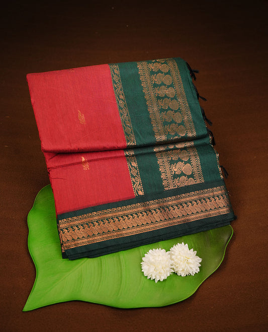 Red colour kalyani cotton saree featuring antique zari motifs on body, complemented by green colour with Antique zari border, paired with matching blouse piece.