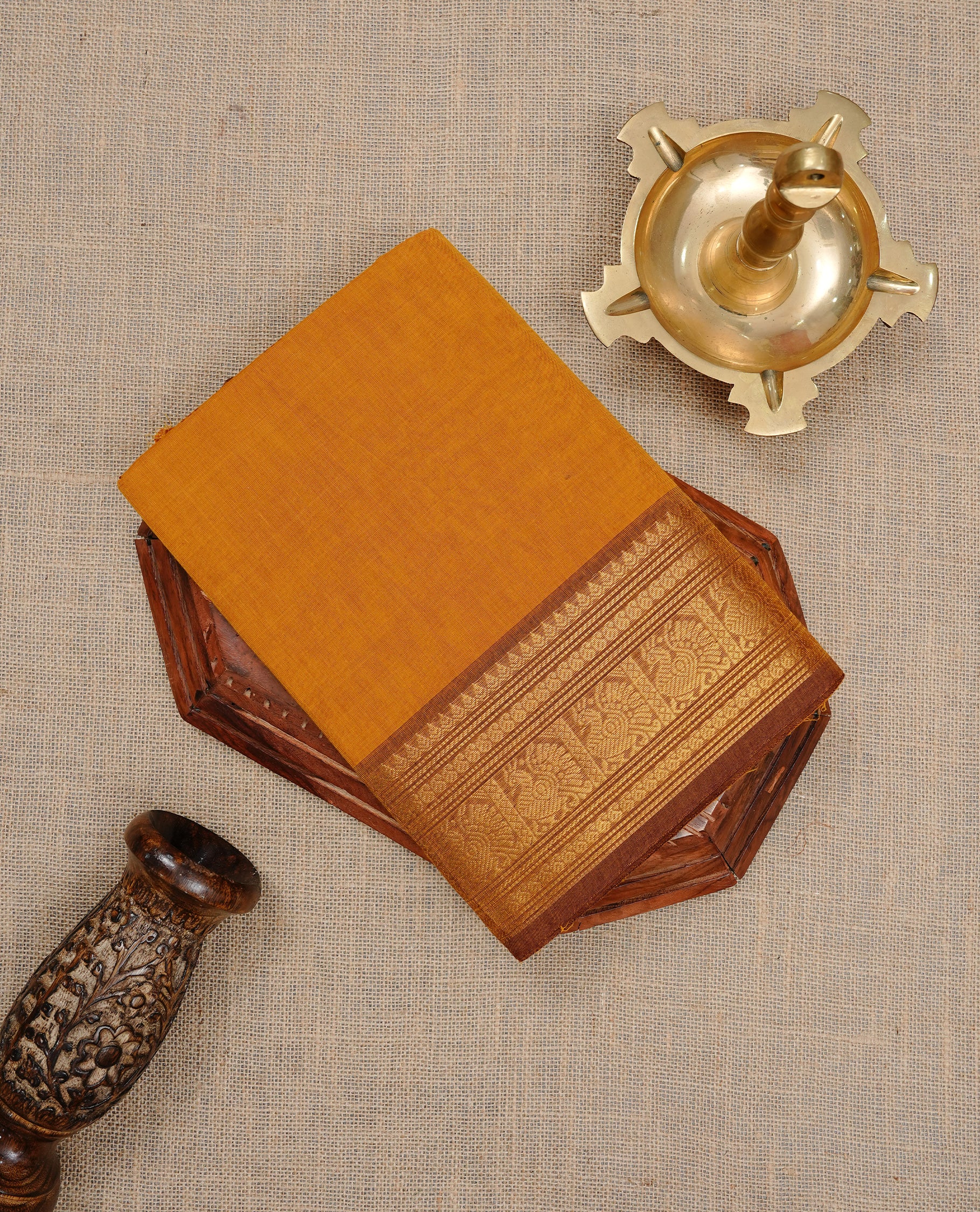 Mustard colour Chettinad cotton saree featuring Elegant plain body, complemented by contrast Light Brown colour with gold zari border, paired with matching blouse piece.