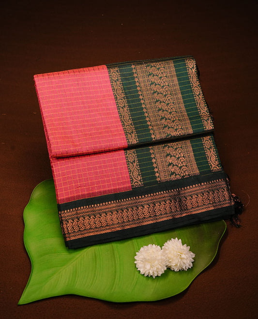 Magenta colour kalyani cotton saree featuring antique zari check pattern on body, complemented by green colour with Antique zari border, paired with matching blouse piece.