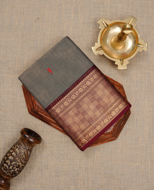 Grey colour Chettinad cotton saree featuring motifs on body , complemented by contrast Maroon colour with zari border, comes with matching blouse piece.