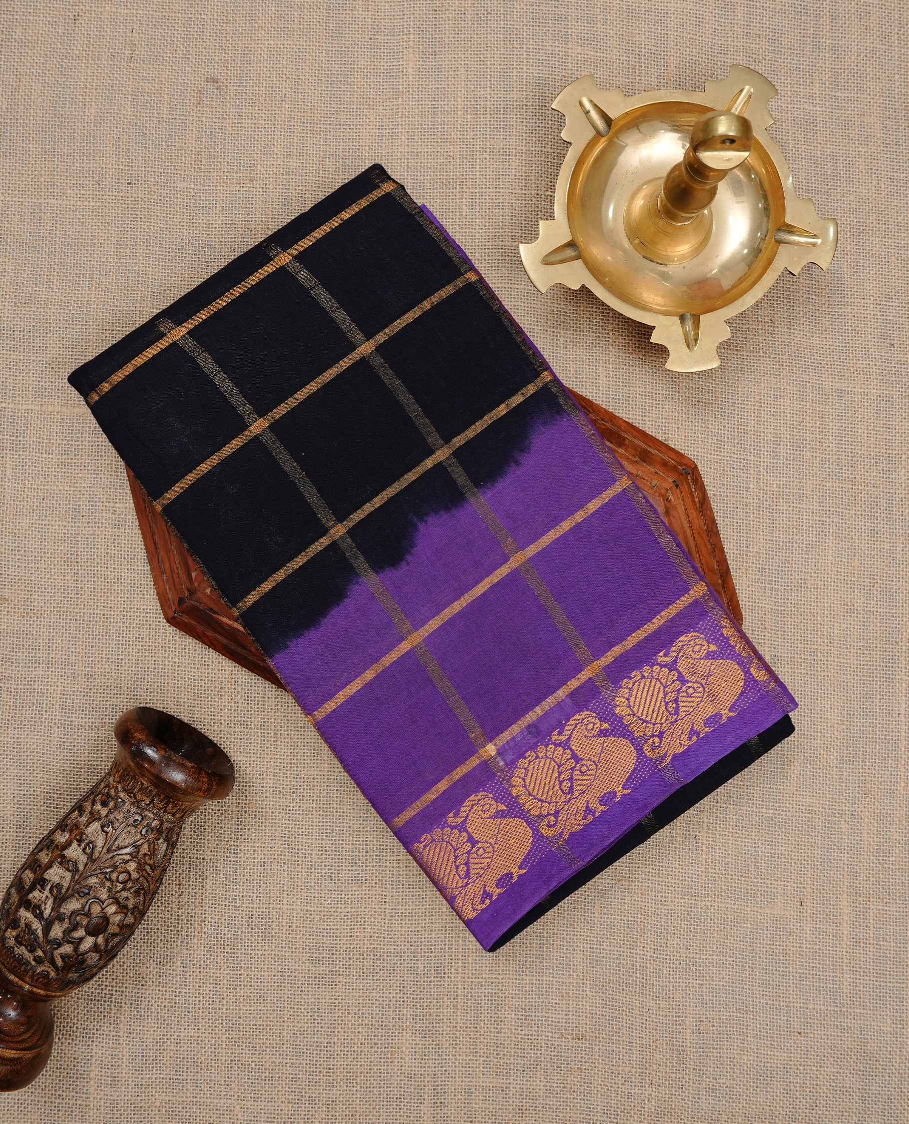 Black colour Sungudi cotton saree featuring Gold zari Check pattern on body, Gold zari Peacock design on Dyed Violet colour design border, paired with matching blouse piece.