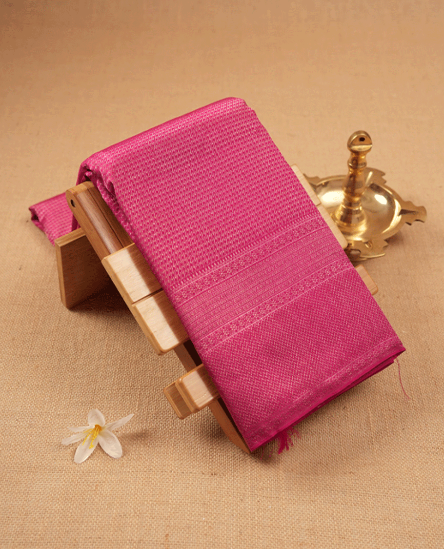 Dark pink Colour Manthrakodi saree featuring an antique zari brocade pattern on the body, complemented by a traditional Laddu Kamalam brocade border and a matching brocade blouse.