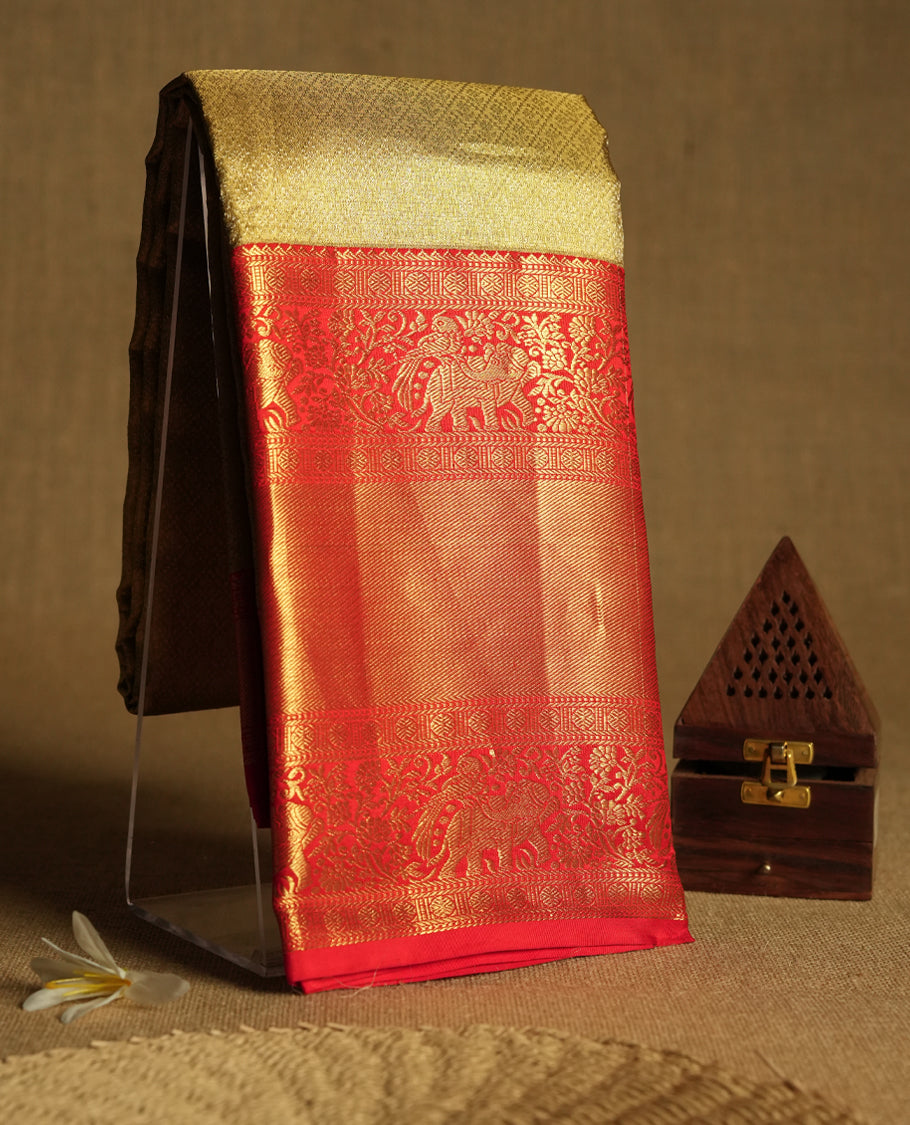 Gold Colour Kancheepuram tissue silk saree featuring an intricately woven antique zari jacquard design on the body, elegantly complemented by a bright red traditional border with elephant, bird, and Rudraksham motifs, and paired with a matching blouse.